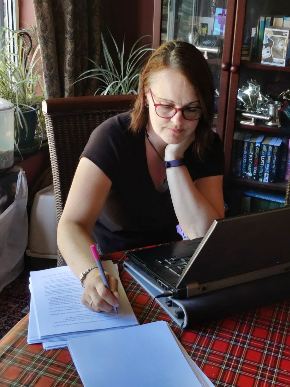 picture of Louise with her laptop and writing down ideas...