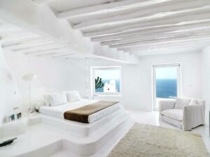 a beautiful, white, green bedroom with sea views